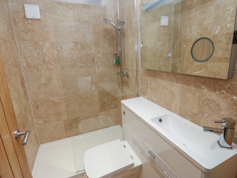 A bathroom with a shower, toilet, and sink at Cottage 9 in Brandon, County Durham