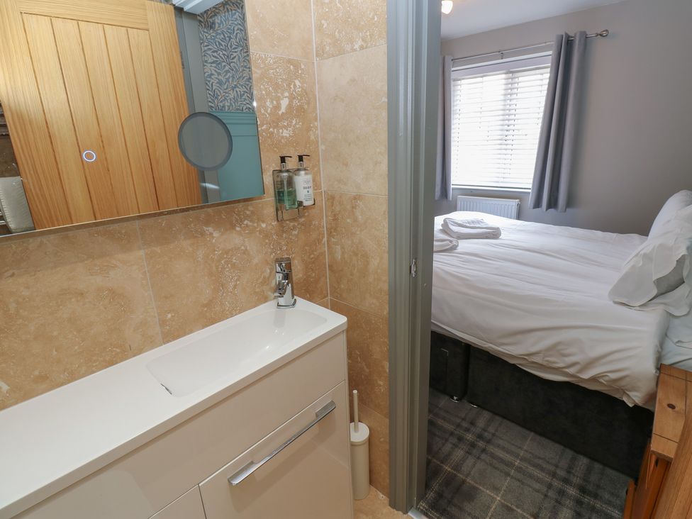 A bathroom with a sink and mirror at Cottage 9 in Brandon, County Durham