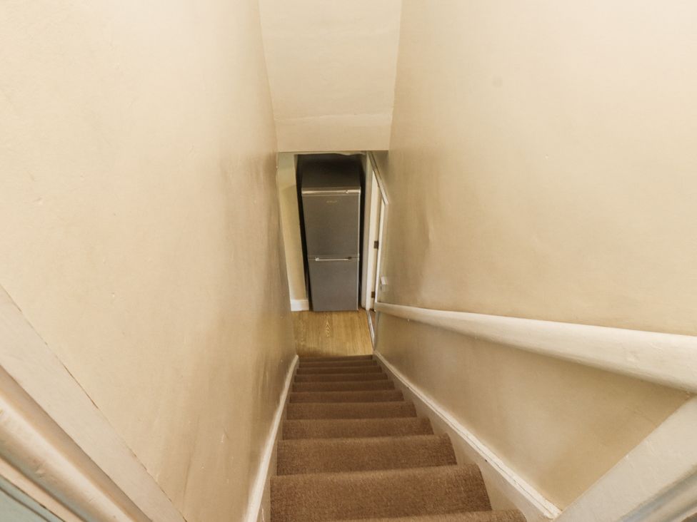 A staircase leading to a fridge at Sygun Cottage in Nant Gwynant