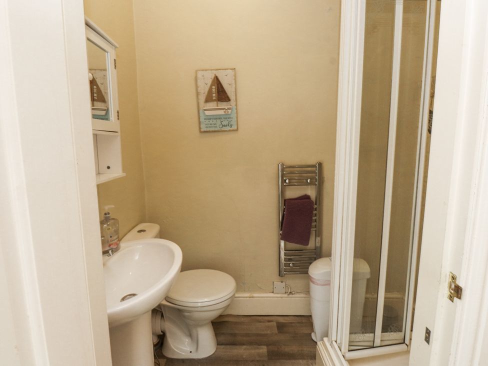 A bathroom with a toilet and sink at Sygun Cottage in Nant Gwynant
