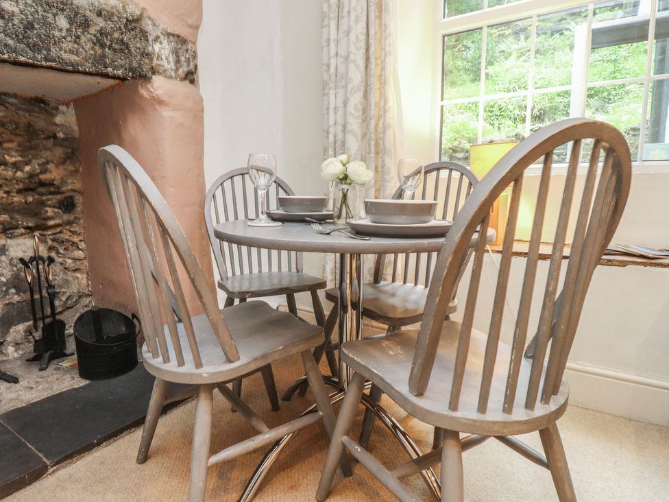 A dining room with a table and chairs at Tryfan Cottage in Nant Gwynant