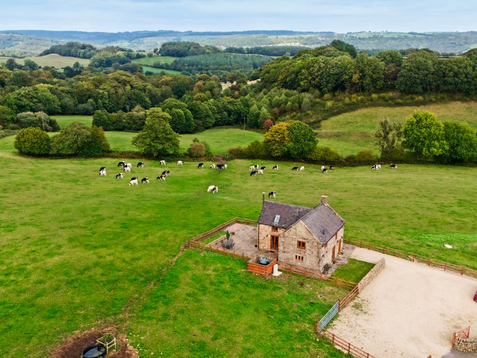An aerial view of a house with cows in a field at Lane Head Cottage Alderwasley near Wirksworth