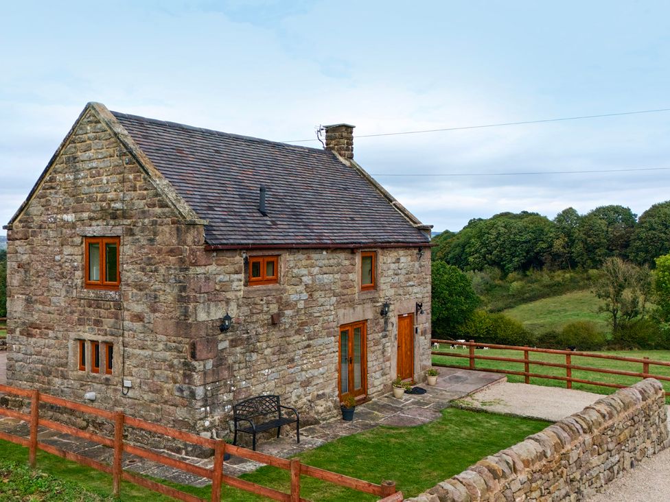 A house with a bench and pathway at Lane Head Cottage in Alderwasley near Wirksworth
