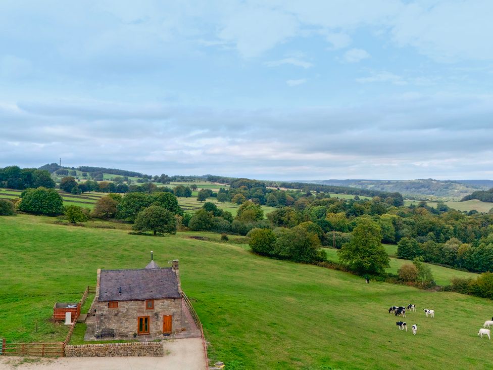 A house surrounded by fields and trees at Lane Head Cottage Alderwasley near Wirksworth