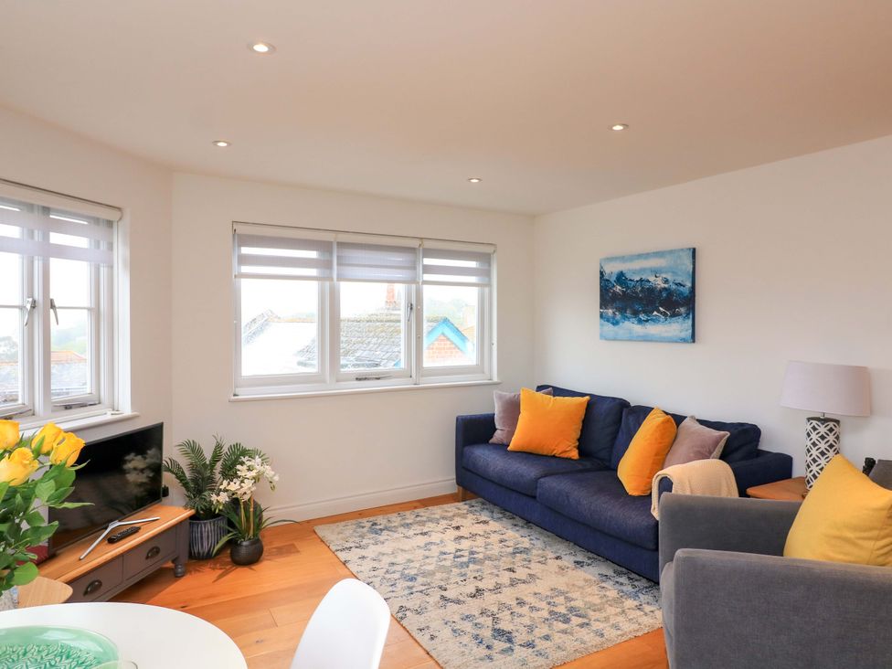 A living room with a sofa and coffee table at 61B Fore Street in Kingsbridge