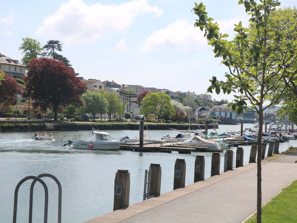 A view of boats on a river with houses and trees at 61B Fore Street in Kingsbridge