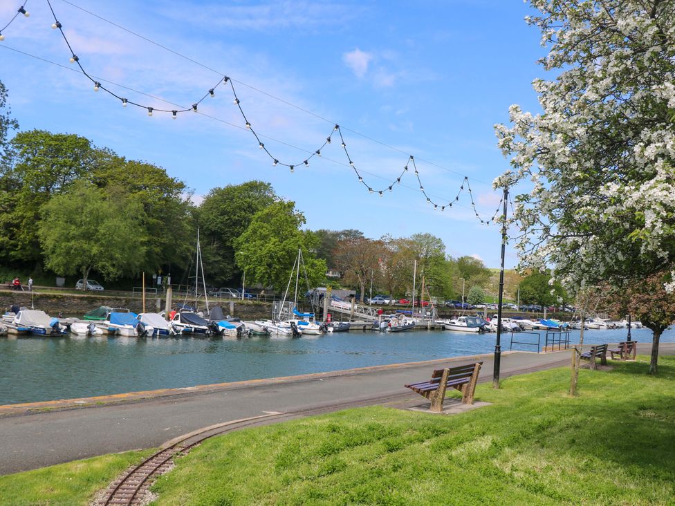 A view of a marina with boats and benches at 61B Fore Street in Kingsbridge
