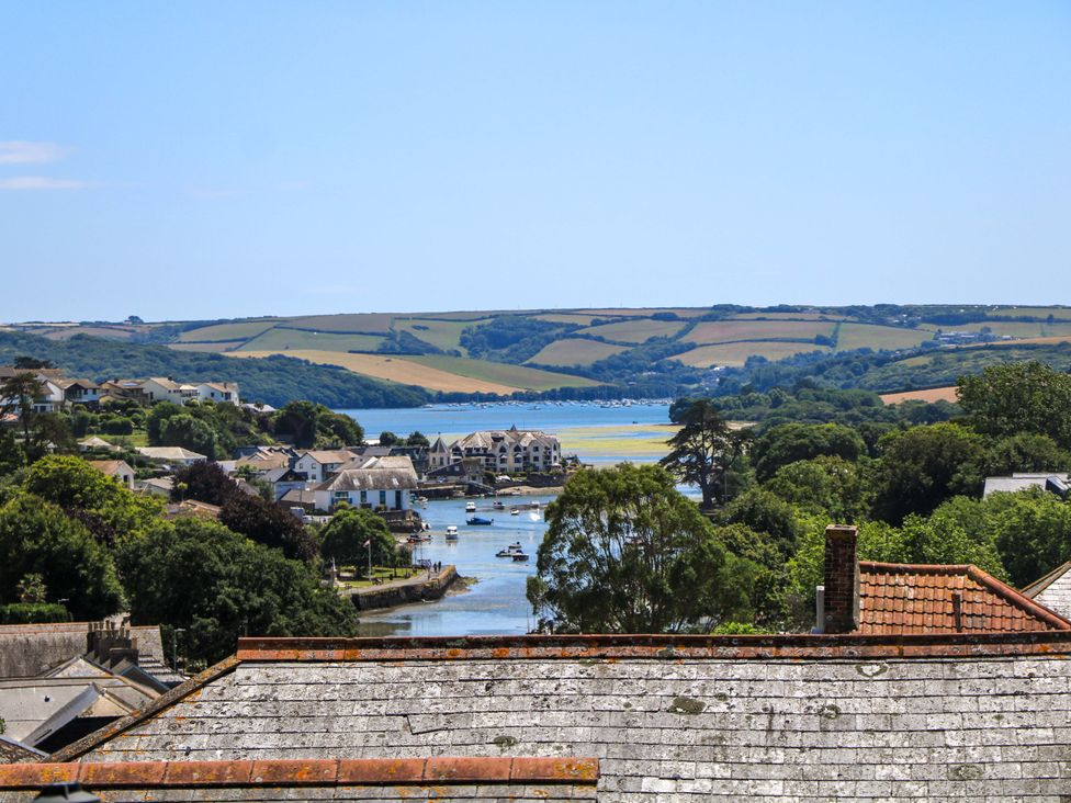A view of a river and boats with houses and hills in the background at 61B Fore Street in Kingsbridge