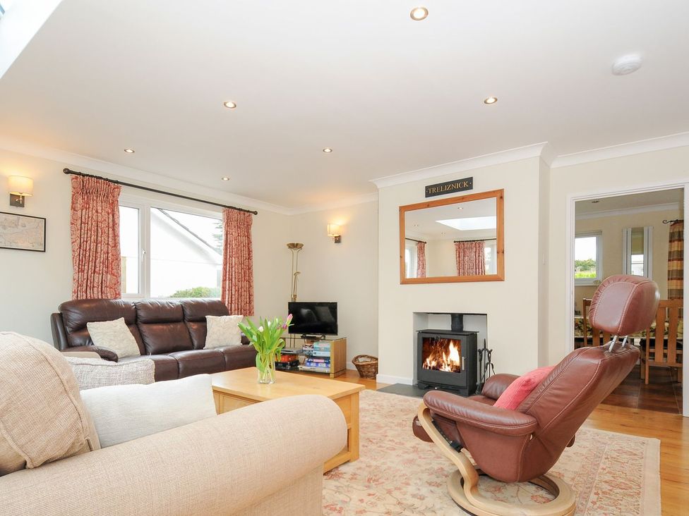 A living room with a fireplace and sofa at Chimings in Rock