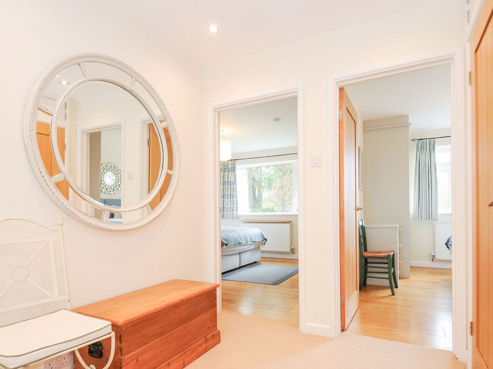 A hallway with a chair and mirror at Chimings in Rock