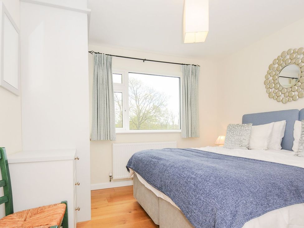 A bedroom with a bed, window and wardrobe at Chimings in Rock