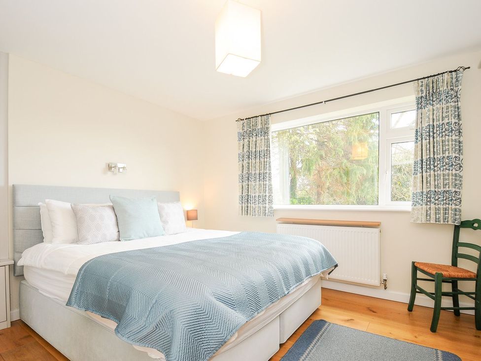 A bedroom with a bed and window at Chimings in Rock
