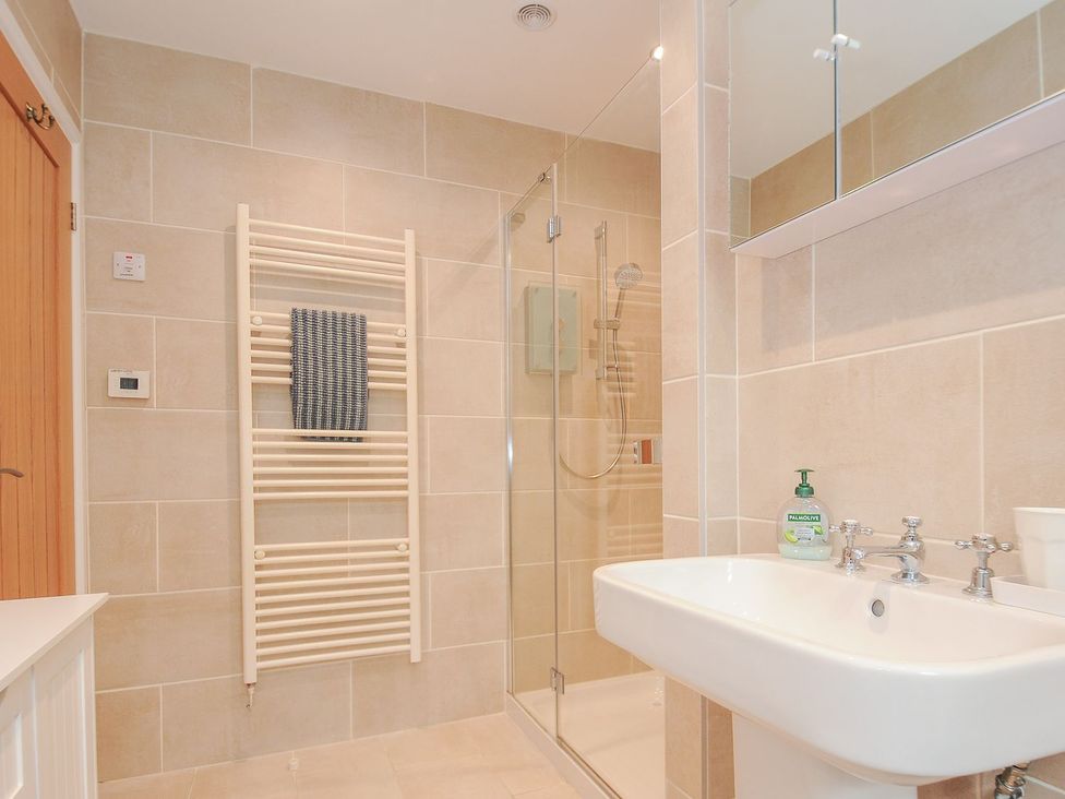 A bathroom with a shower and wash basin at Chimings Rock