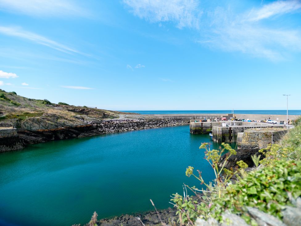 A harbor with a concrete pier and clear blue water at Annexe at Ty Moel Isaf in Pengorffwysfa near Amlwch