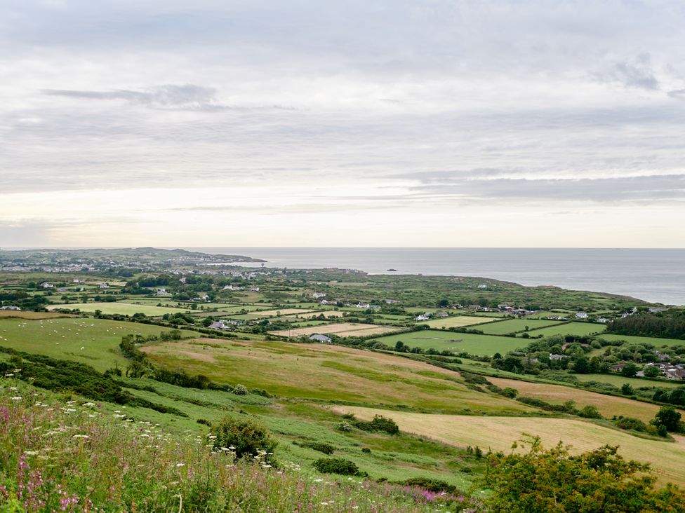 A coastal landscape with fields houses and the sea at Annexe at Ty Moel Isaf in Pengorffwysfa near Amlwch