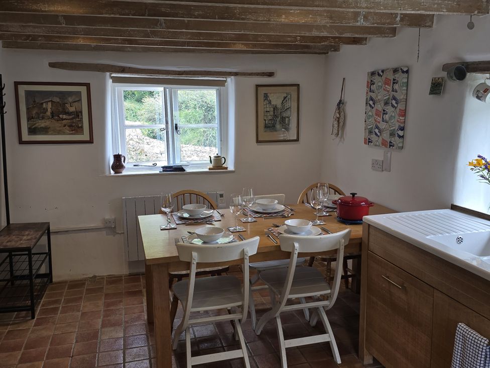A dining room with a table set for meals at Picket Mead in Southleigh near Colyton