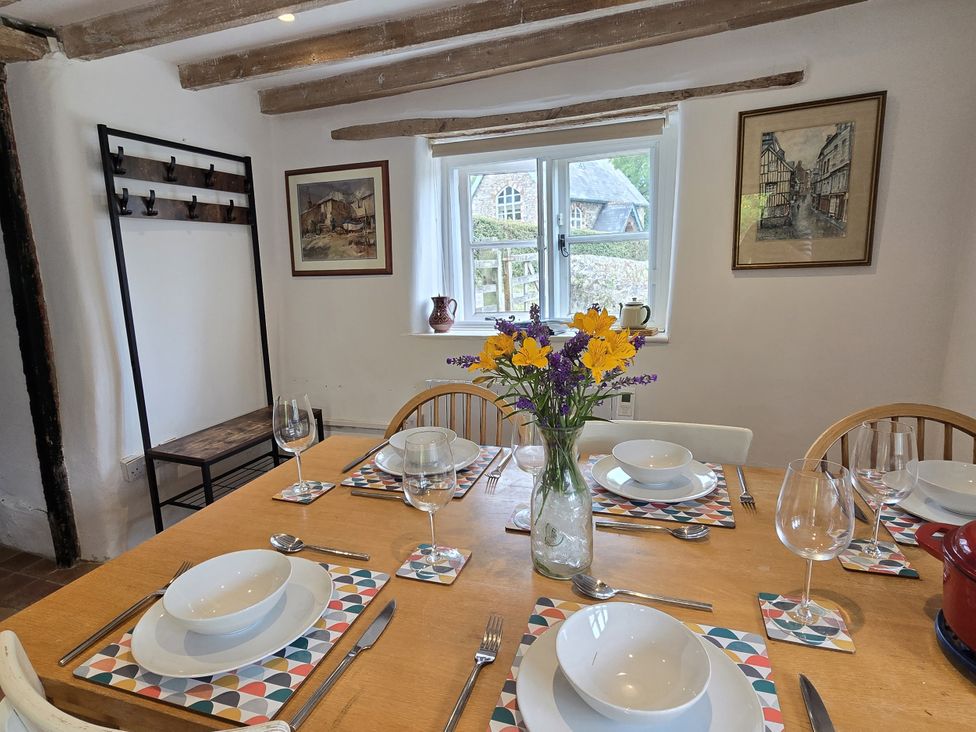 A dining room with a table set for a meal at Picket Mead Southleigh near Colyton
