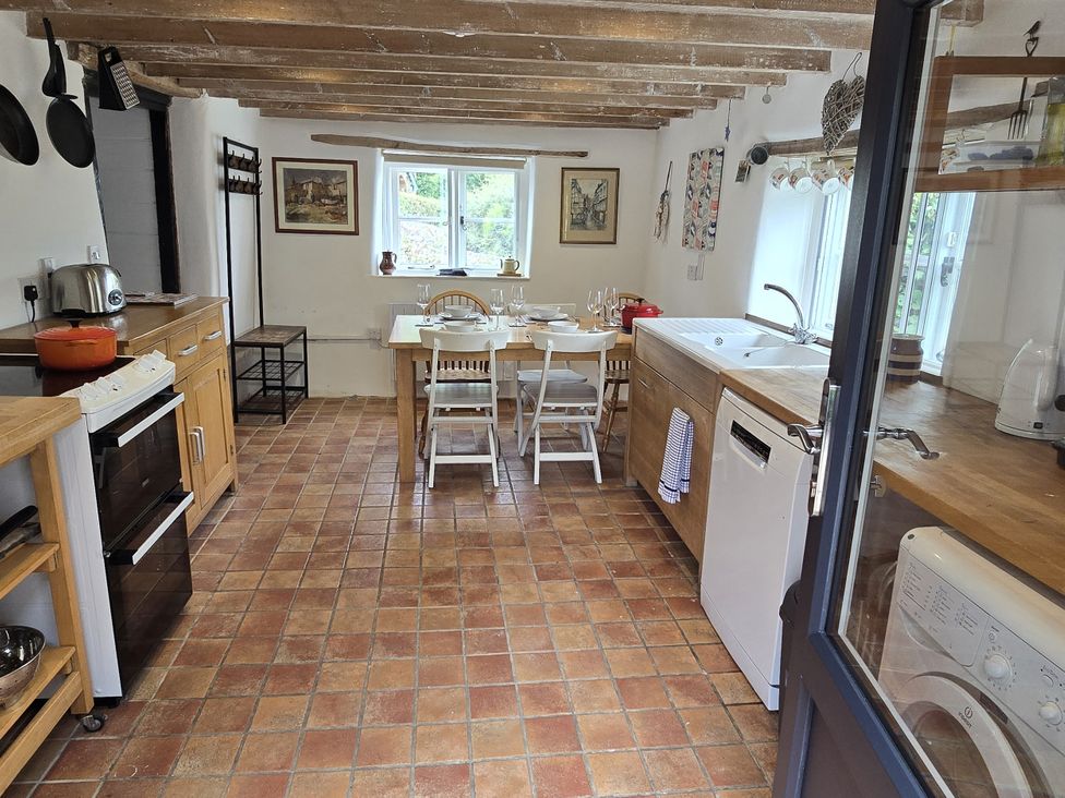 A kitchen with a dining table and chairs at Picket Mead Southleigh near Colyton