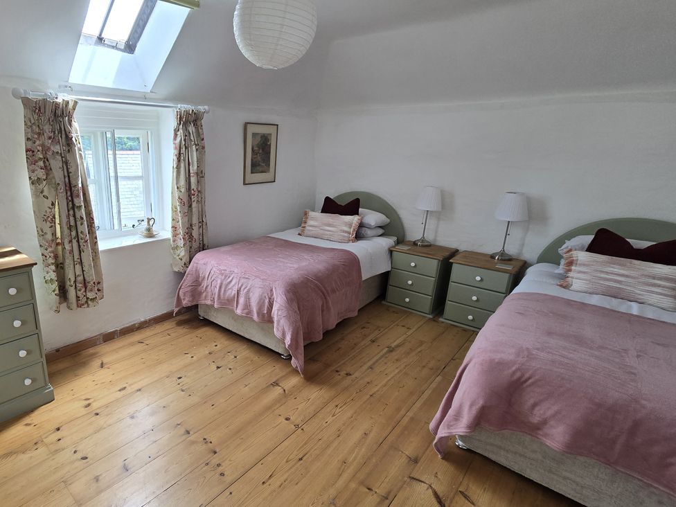A bedroom with two beds and bedside tables at Picket Mead Southleigh near Colyton