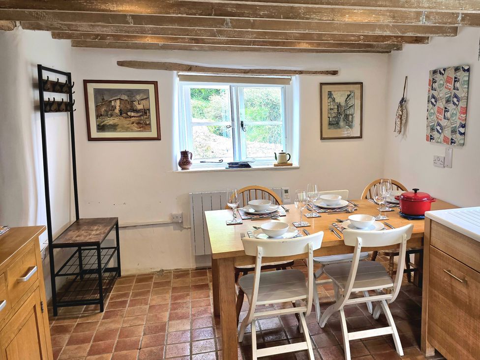 A kitchen with a dining table and chairs at Picket Mead Southleigh near Colyton