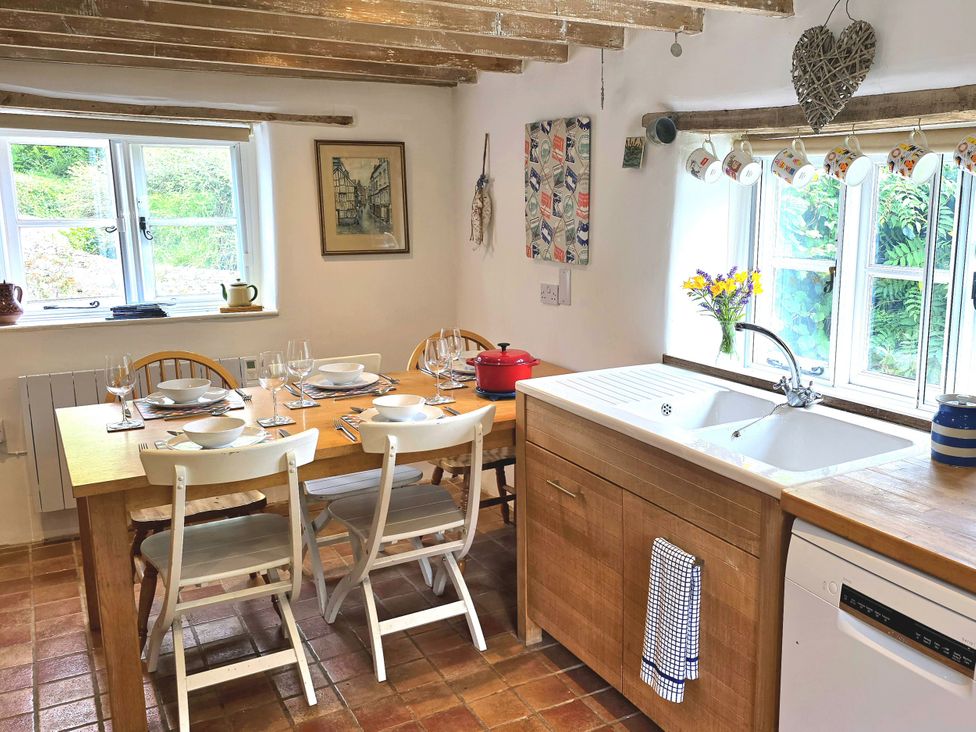A kitchen with a dining table and sink at Picket Mead Southleigh near Colyton