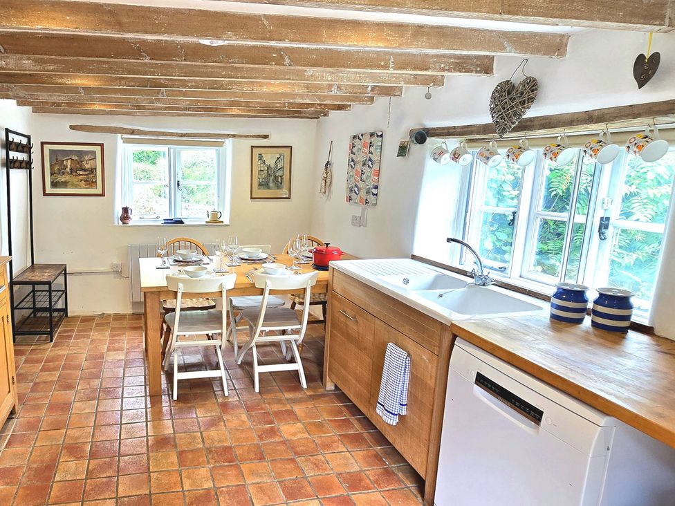 A kitchen with a table and chairs at Picket Mead Southleigh near Colyton