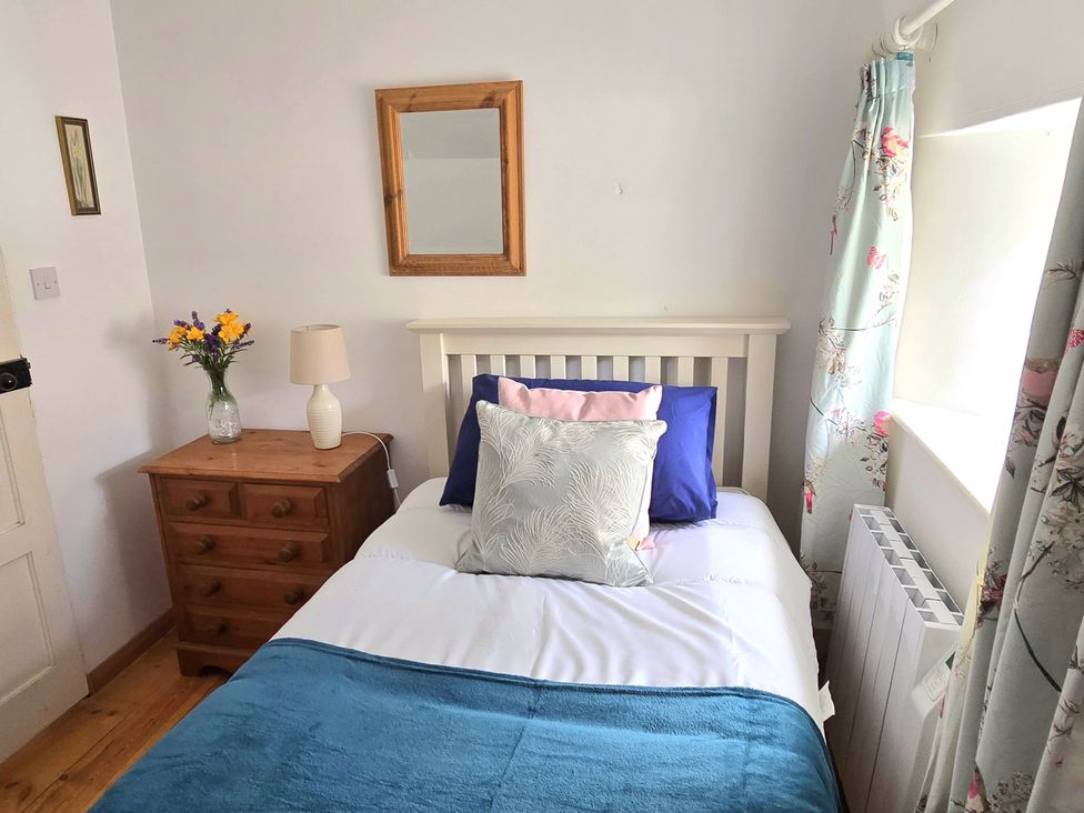 A bedroom with a bed and bedside table at Picket Mead Southleigh near Colyton