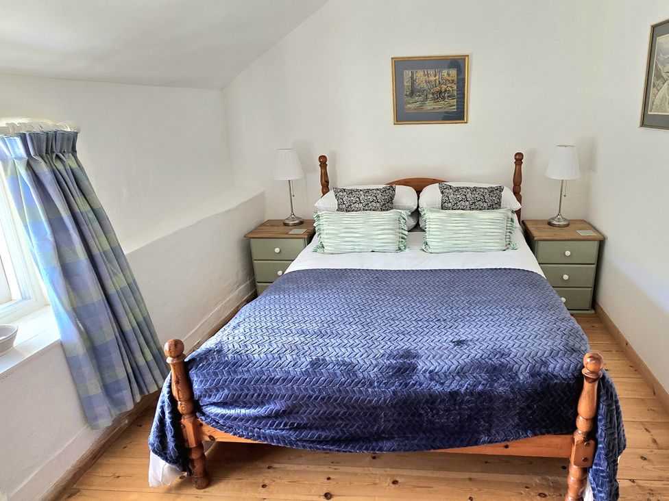 A bedroom with a bed and lamps at Picket Mead Southleigh near Colyton
