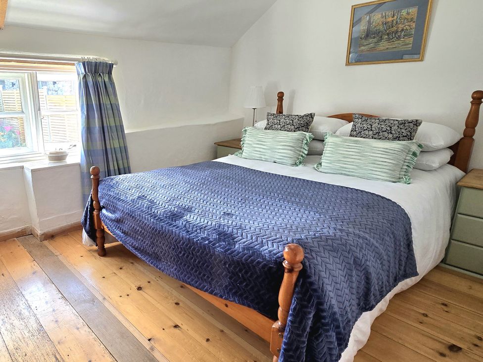 A bedroom with a bed and window at Picket Mead Southleigh near Colyton