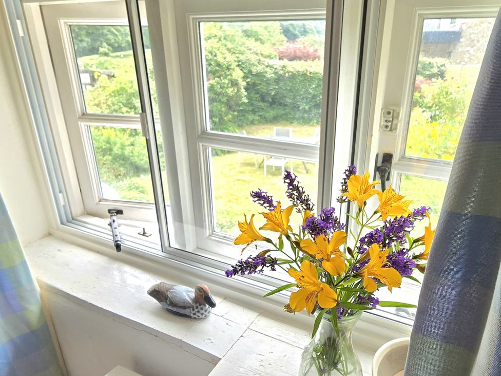 A window with flowers in a vase at Picket Mead Southleigh near Colyton