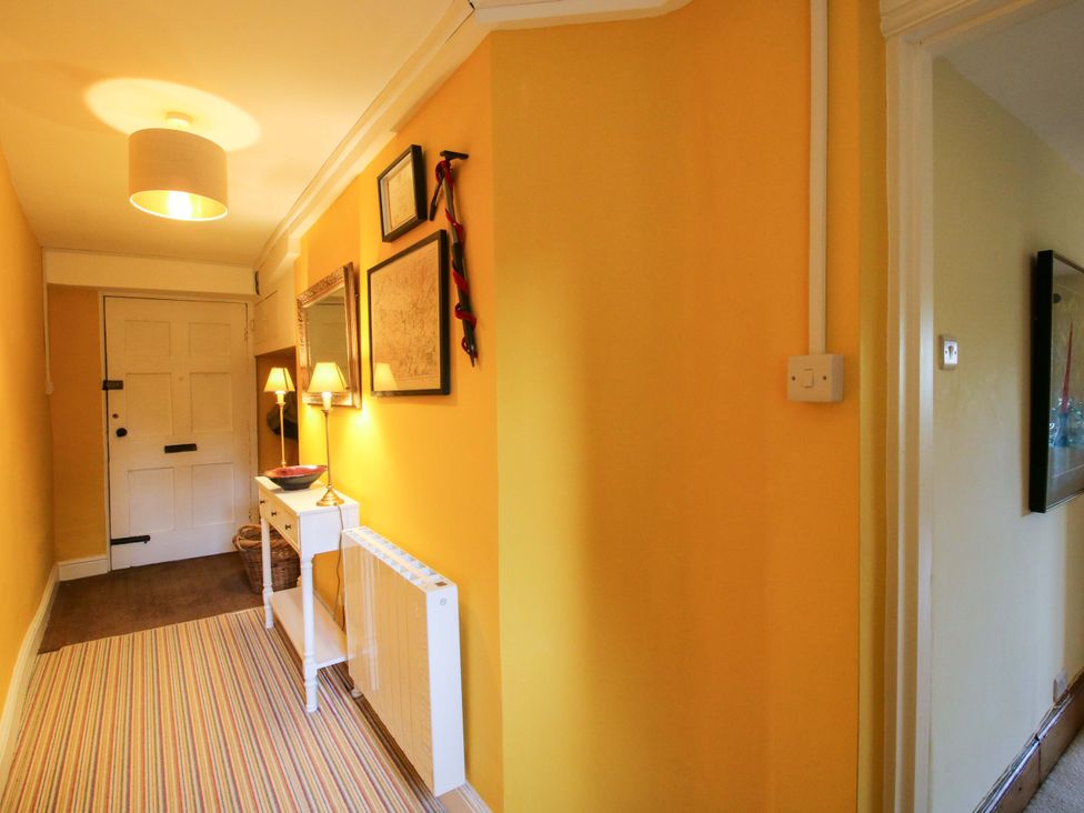A hallway with a console table and lamp at 41 High Street in Bishop's Castle