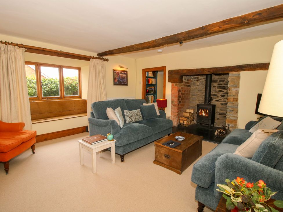 A living room with a fireplace and sofas at 41 High Street in Bishop's Castle