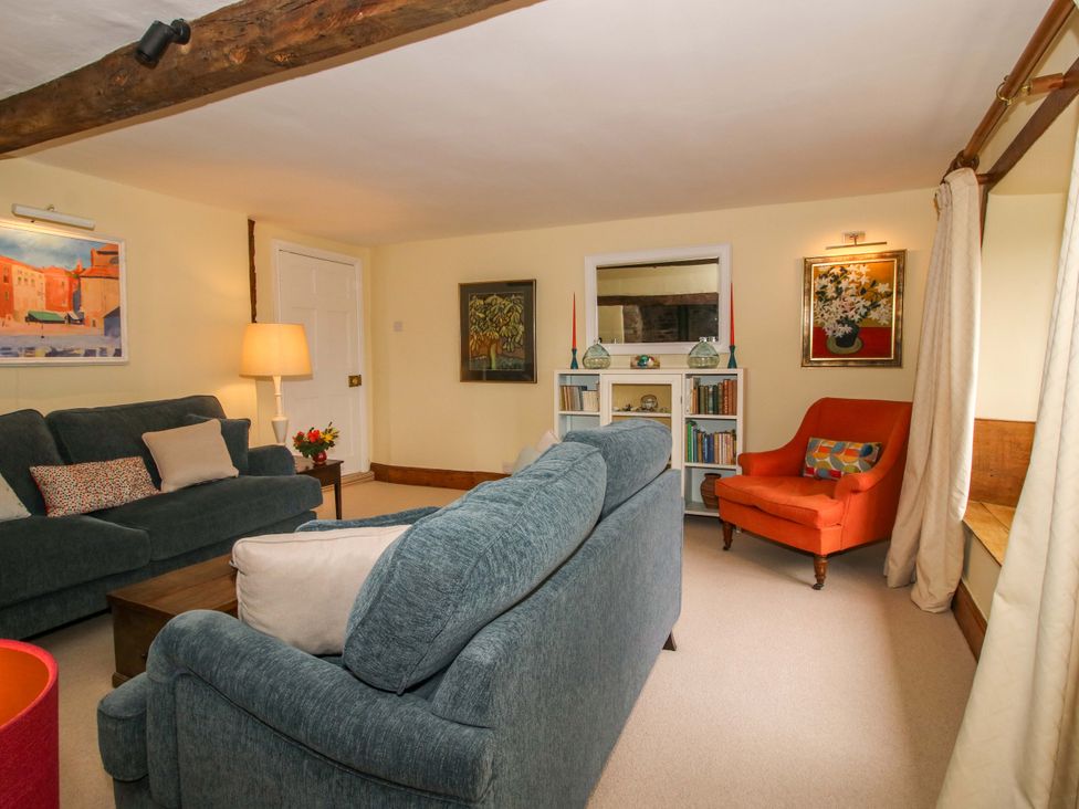 A living room with a sofa and armchair at 41 High Street in Bishop's Castle
