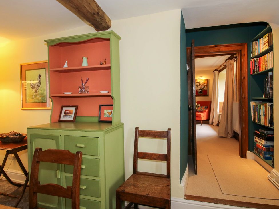 A living room with a cabinet and facing door at 41 High Street in Bishop's Castle