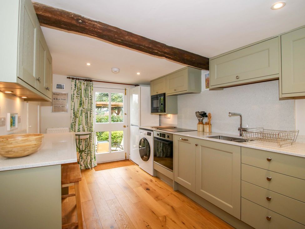 A kitchen with cabinets and appliances at 41 High Street in Bishop's Castle
