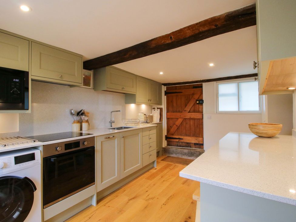 A kitchen with appliances and a wooden door at 41 High Street, Bishop's Castle
