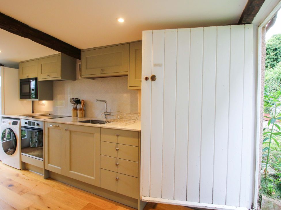 A kitchen with a sink and cupboards at 41 High Street in Bishop's Castle