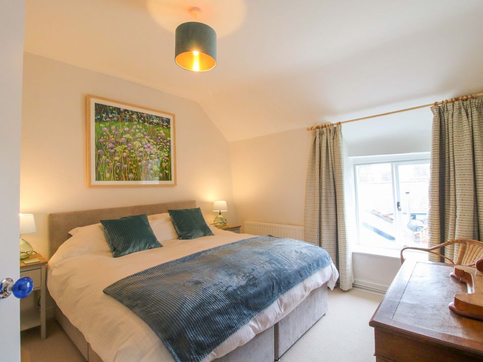 A bedroom with a bed and a nightstand at 41 High Street, Bishop's Castle