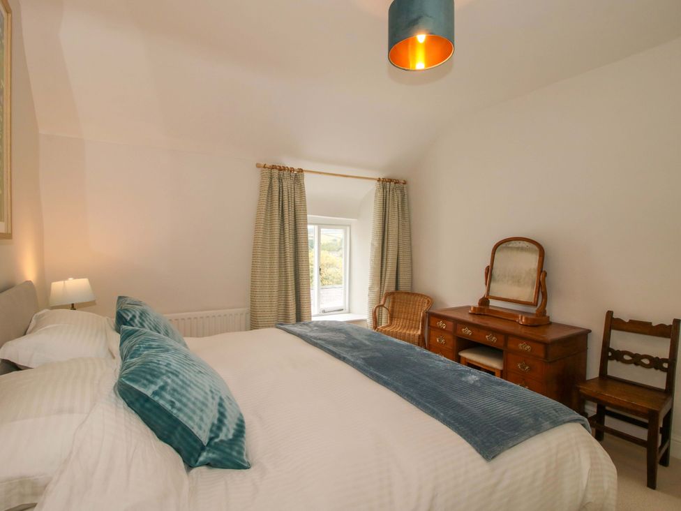 A bedroom with a bed and dressing table at 41 High Street in Bishop's Castle