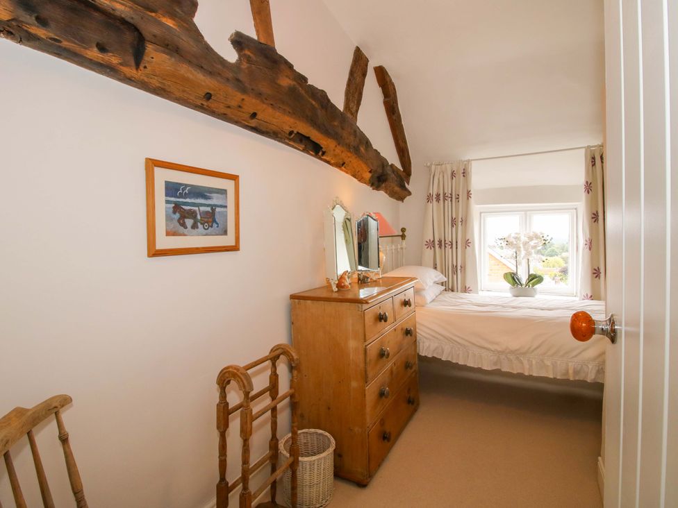 A bedroom with a bed and dresser at 41 High Street Bishop's Castle