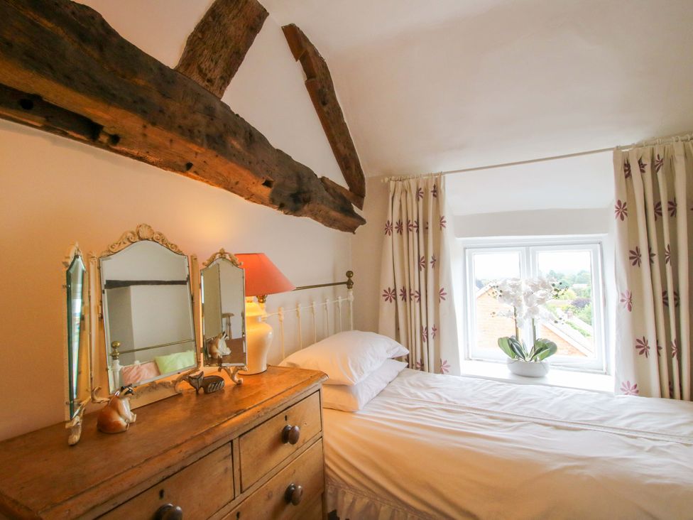 A bedroom with a bed and a dressing table at 41 High Street Bishop's Castle