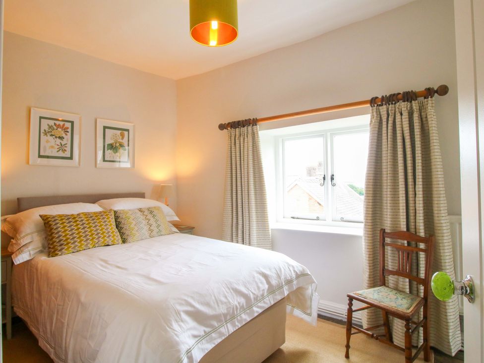 A bedroom with a bed and window at 41 High Street Bishop's Castle