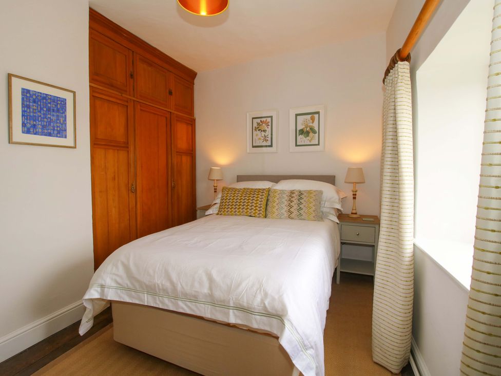 A bedroom with a bed and artwork at 41 High Street in Bishop's Castle
