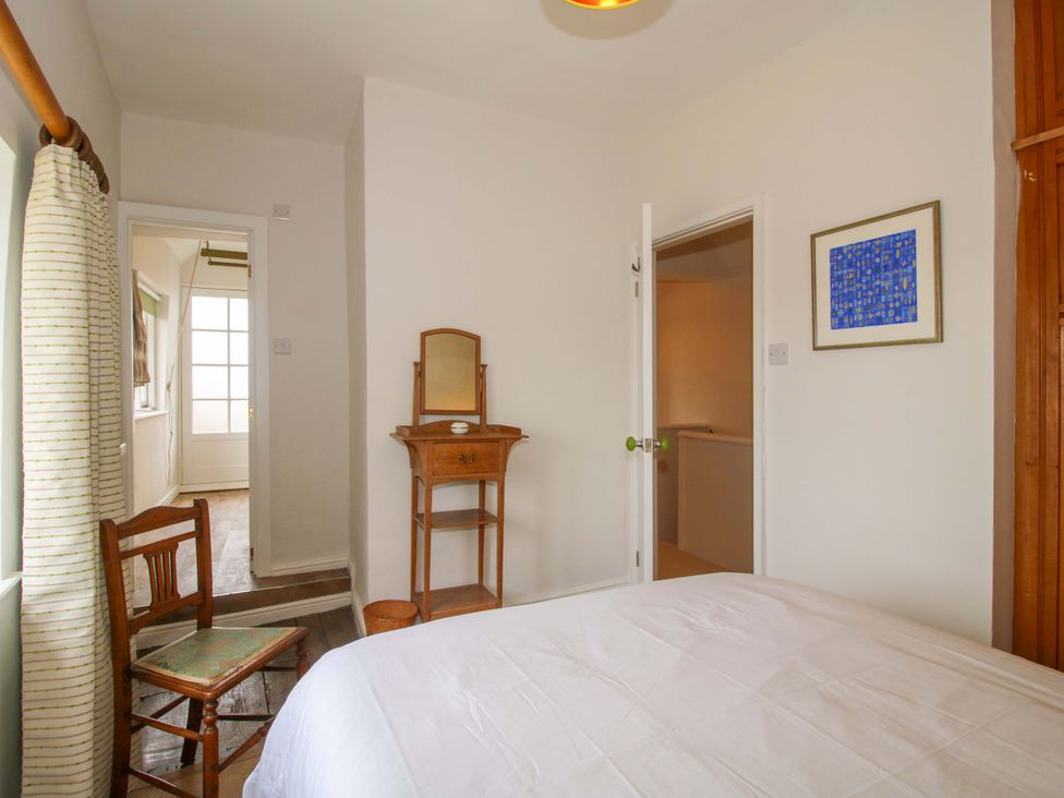A bedroom with a bed and a mirror at 41 High Street, Bishop's Castle