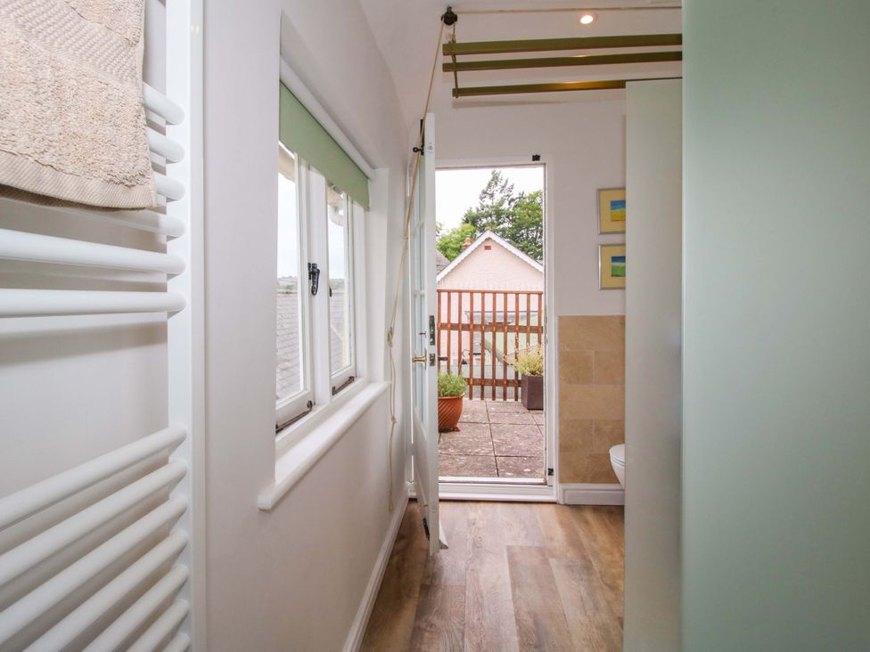 A bathroom with a towel warmer and a door leading to an outdoor area at 41 High Street in Bishop's Castle