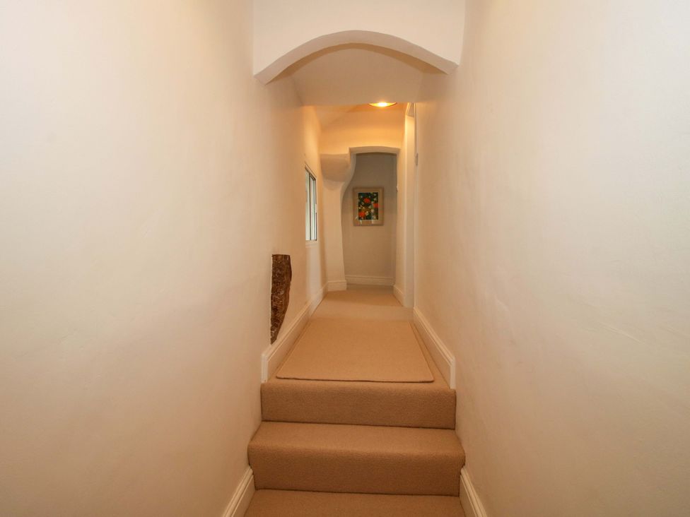 A hallway with steps and artwork at 41 High Street, Bishop's Castle