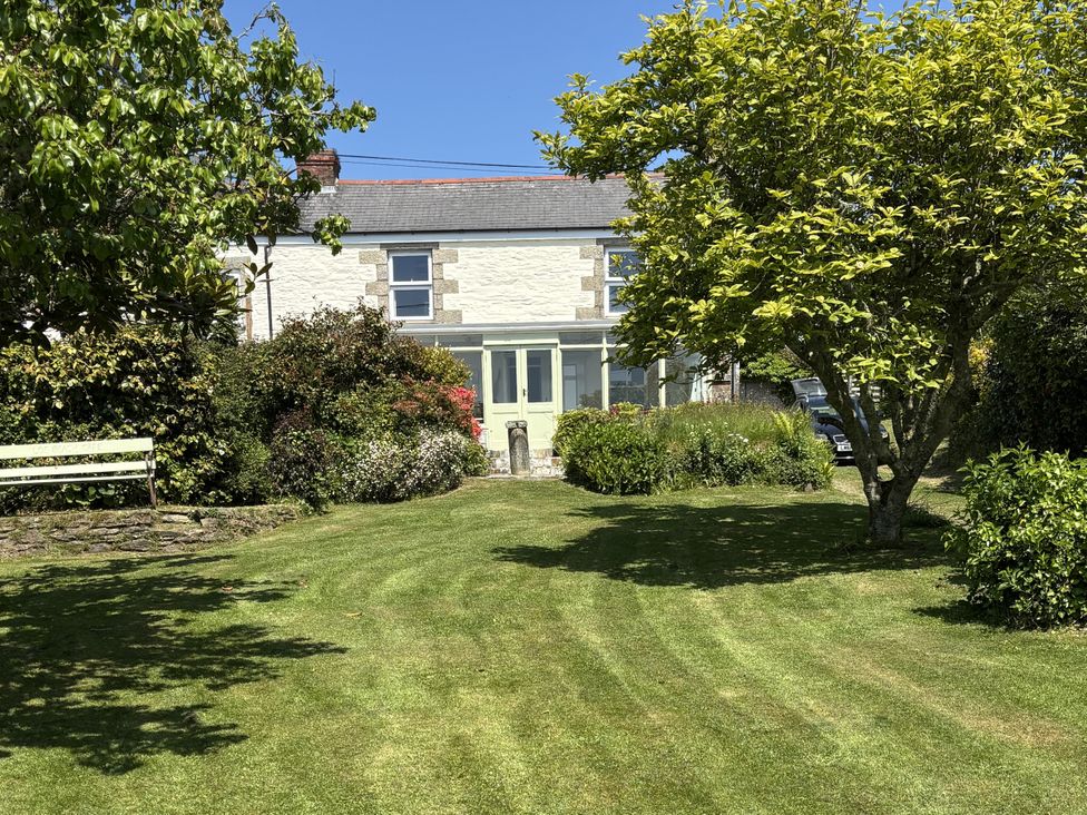 A house with a garden and bench in front at Nanvivian Feock near Truro