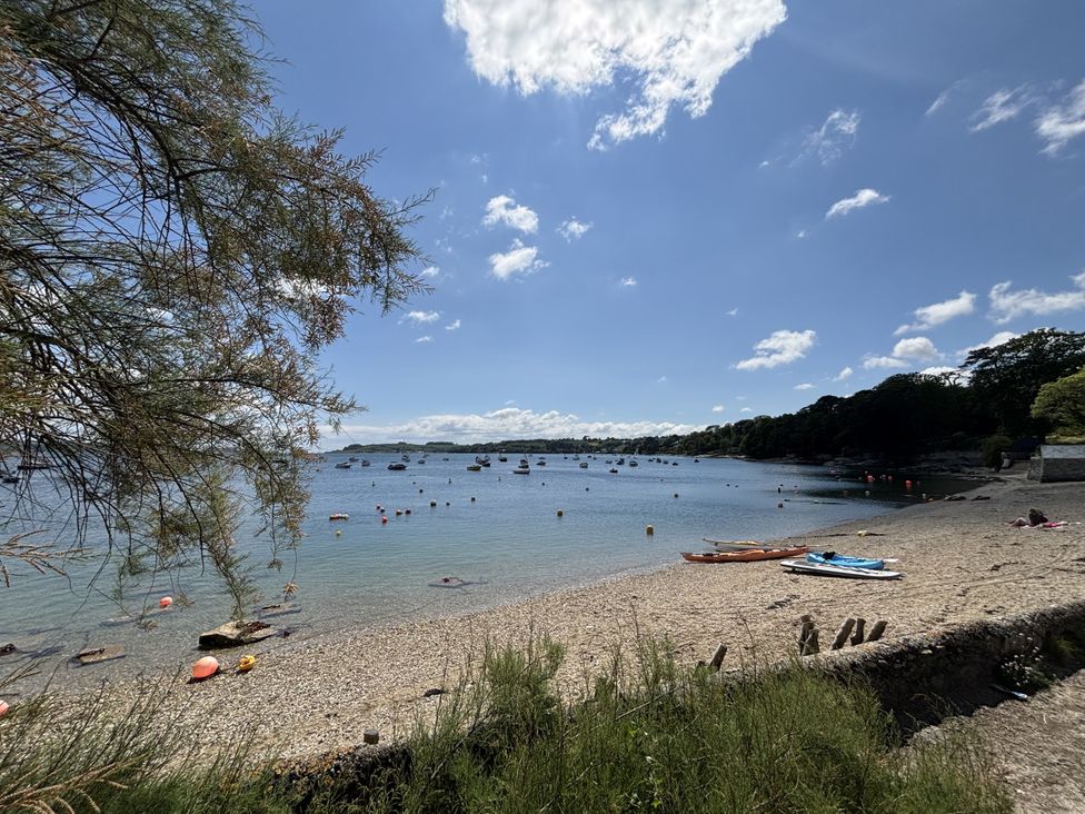 A beach with boats and kayaks at Nanvivian Feock near Truro