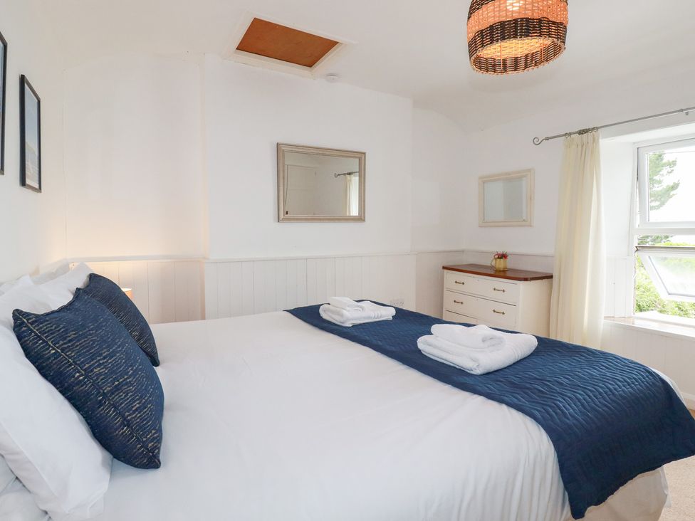 A bedroom with a bed and dresser at Nanvivian in Feock near Truro