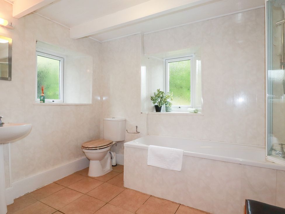 A bathroom with a sink, toilet, and bathtub at Nanvivian in Feock near Truro